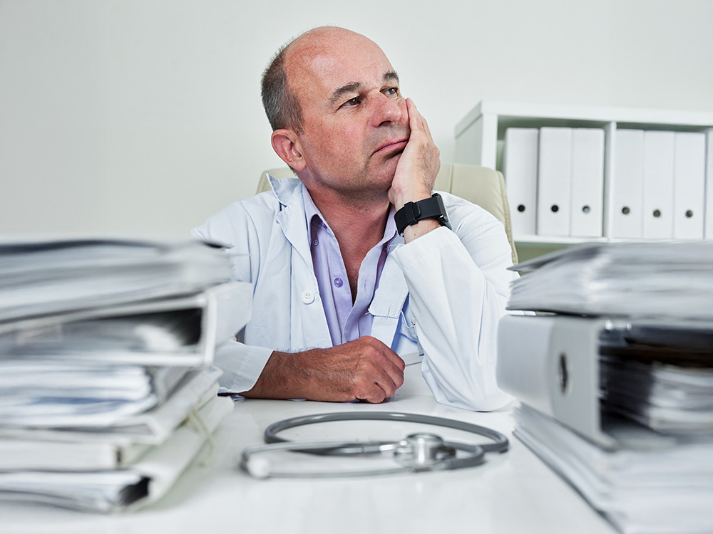 Doctor overwhelmed by paperwork